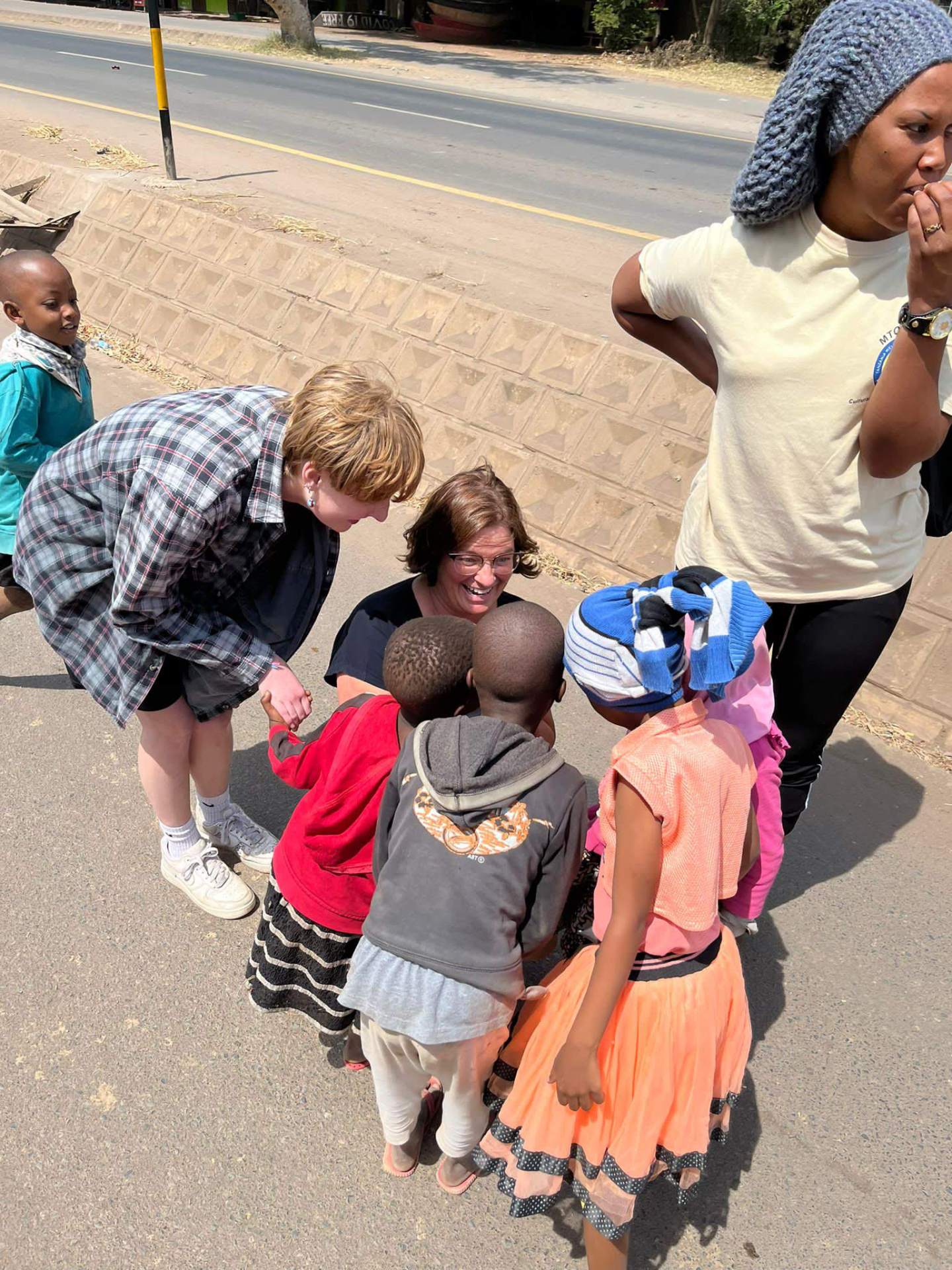 Visitors meeting local children in the community